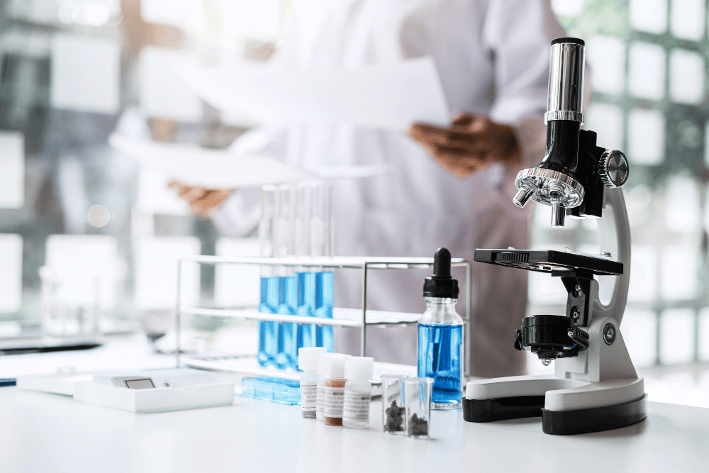 a microscope and test tubes on a table